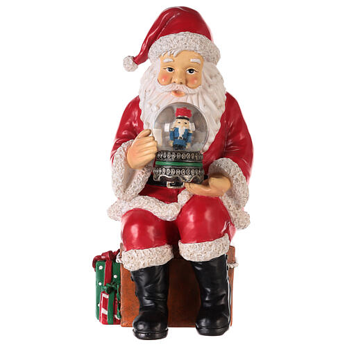 Santa with nutcracker snow globe 10x5x6 in 1