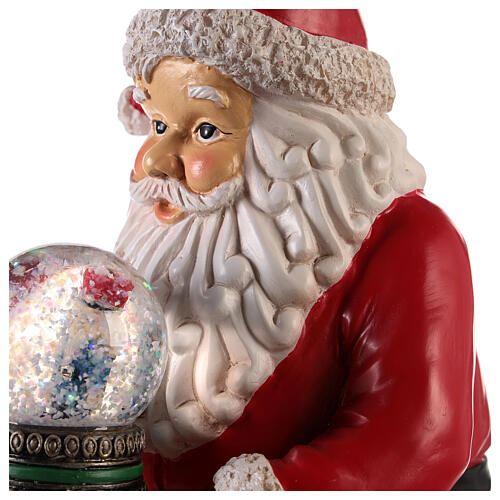 Santa with nutcracker snow globe 10x5x6 in 2