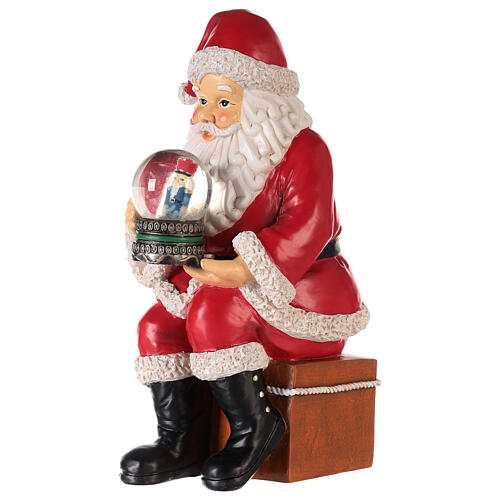 Santa with nutcracker snow globe 10x5x6 in 3