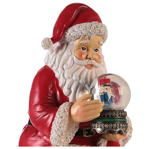 Santa with nutcracker snow globe 10x5x6 in 4