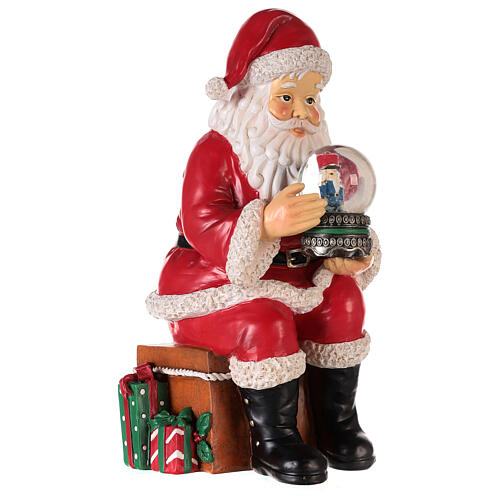 Santa with nutcracker snow globe 10x5x6 in 5
