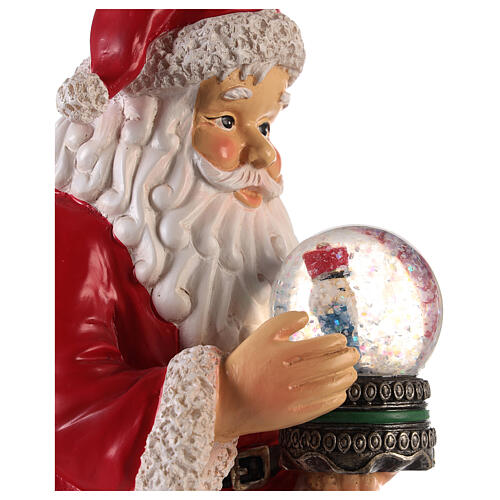 Santa with nutcracker snow globe 10x5x6 in 6