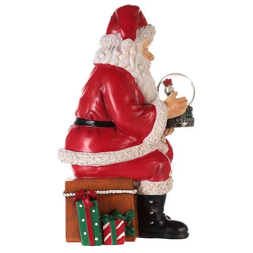Santa with nutcracker snow globe 10x5x6 in 7