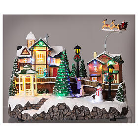 Christmas village set: houses and Santa in motion 10x12x6 in