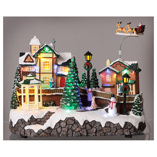 Christmas village set: houses and Santa in motion 10x12x6 in 2