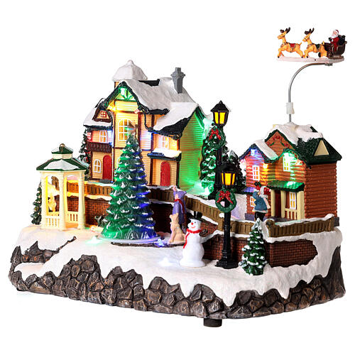 Christmas village set: houses and Santa in motion 10x12x6 in 3
