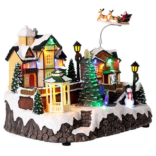 Christmas village set: houses and Santa in motion 10x12x6 in 4