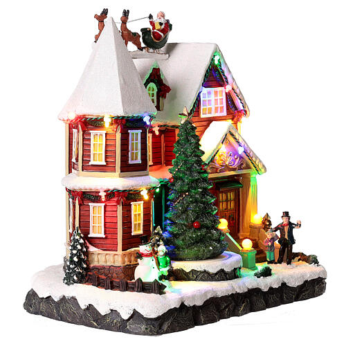 Christmas village set: house with Santa above it 10x10x8 in 5