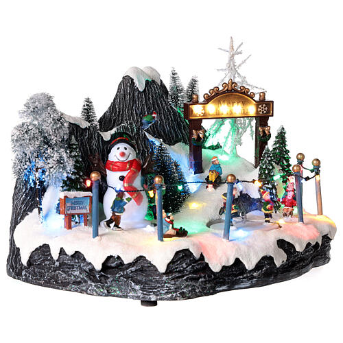 Christmas village set: skaters and snowman 8x14x8 in 4