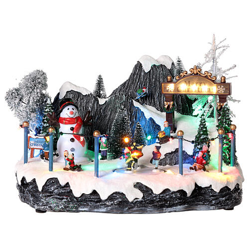 Pueblo navideño patinadores y muñeco de nieve 20x35x20 cm 1