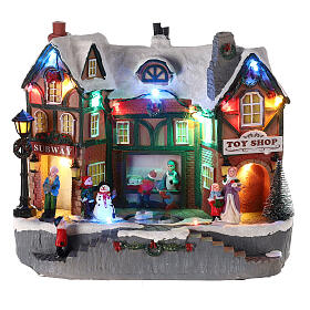 Christmas village set: building and skaters in motion 8x10x6 in