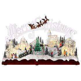 Christmas village set: clear buildings and inscription and skaters in motion 10x16x6 in