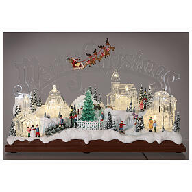Christmas village set: clear buildings and inscription and skaters in motion 10x16x6 in