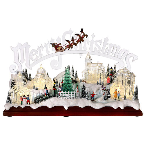 Christmas village set: clear buildings and inscription and skaters in motion 10x16x6 in 1