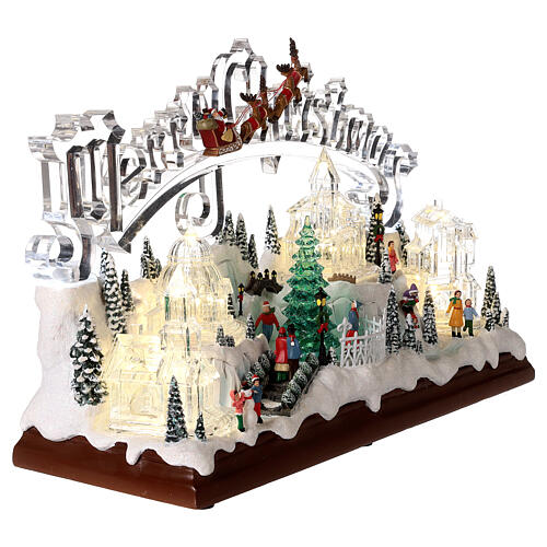 Christmas village set: clear buildings and inscription and skaters in motion 10x16x6 in 4