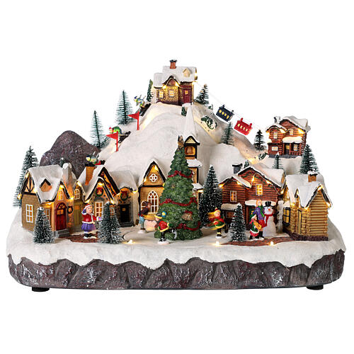 Christmas village set with skiers and Christmas tree in motion 12x16x10 in 1