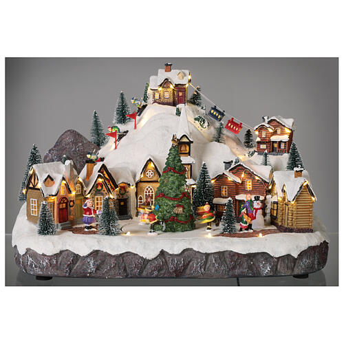 Christmas village set with skiers and Christmas tree in motion 12x16x10 in 2