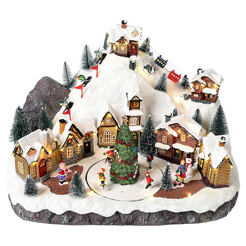Christmas village set with skiers and Christmas tree in motion 12x16x10 in 3