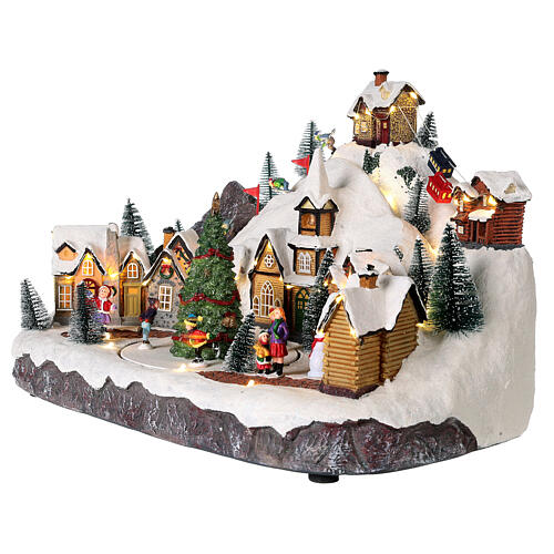 Christmas village set with skiers and Christmas tree in motion 12x16x10 in 4