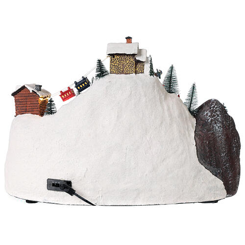 Animated Christmas village with skiers tree 30x40x25 cm 6