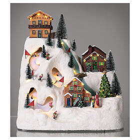 Christmas village with skiers and river 35x30x20 cm