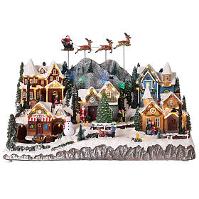 Village de Noël avec Père Noël en traineau 40x60x30 cm