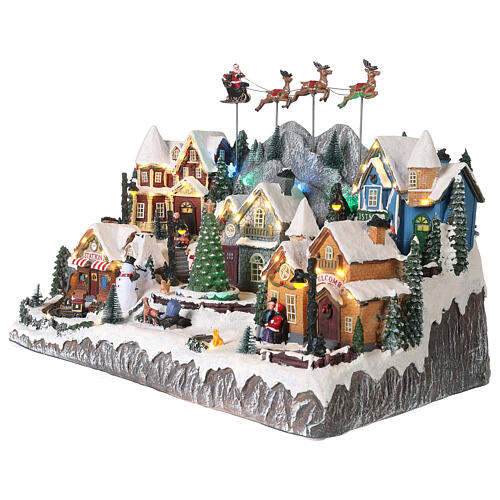 Village de Noël avec Père Noël en traineau 40x60x30 cm 5