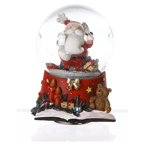 Snow globe with Santa Claus on an open book, music box, 15x10x10 cm 1