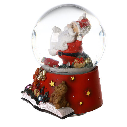 Snow globe with Santa Claus on an open book, music box, 15x10x10 cm 4