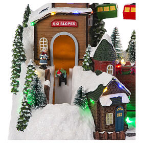 Christmas village setting with skiers and chairlift, 10x12x8 in