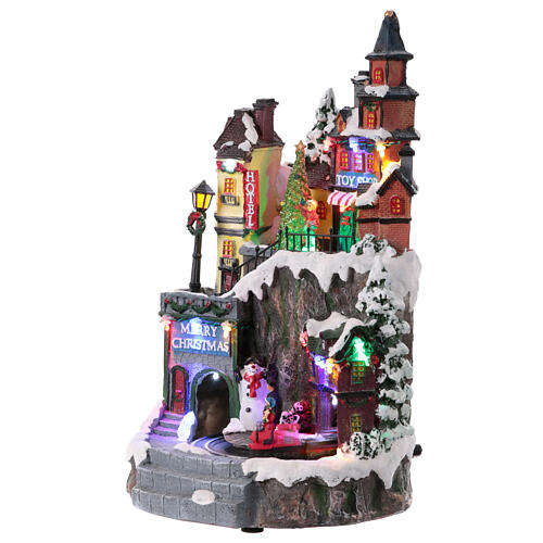 Christmas village set on two levels with train in motion, 14x8x8 in 3