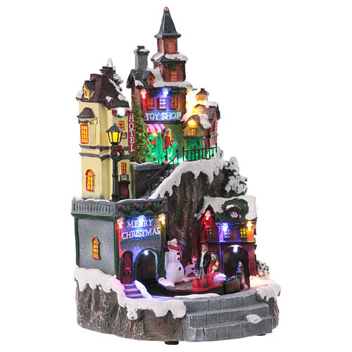Christmas village set on two levels with train in motion, 14x8x8 in 4