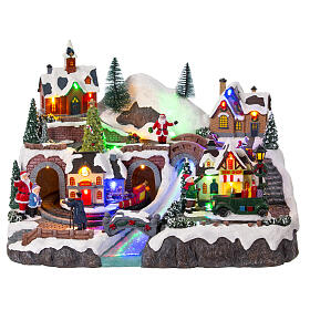 Christmas village set with train and car in motion, 12x16x10 in