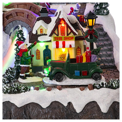 Christmas village set with train and car in motion, 12x16x10 in 5