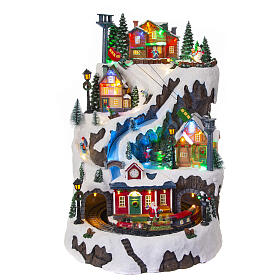 Christmas village set: mountain with train and ice skaters in motion, 18x12x14 in