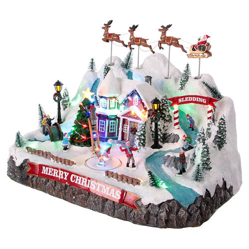 Winterszene, verschneite Berglandschaft mit fliegendem Weihnachtsmann, Bewegung und LED-Beleuchtung – 30×40×30 cm 3