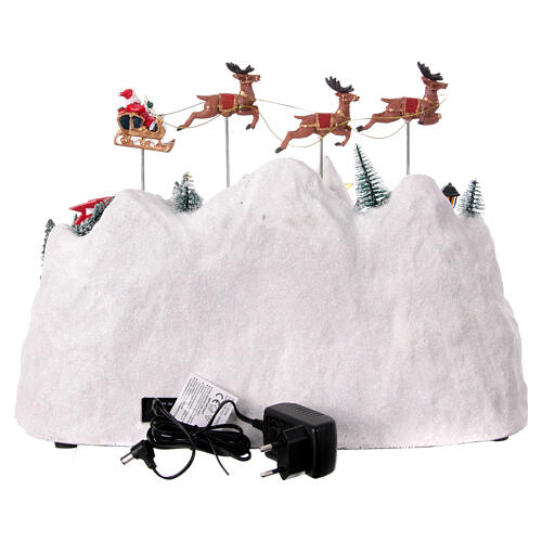 Pueblo montaña nevada Papá Noel volando 30x40x30 cm 5