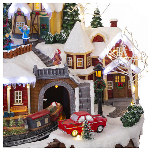 Christmas village set with train and Christmas tree in motion, 14x18x14 in 7