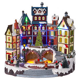 Snowy Christmas village with animated tree, 12x12x8 in