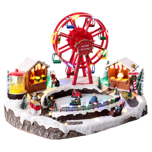 Pueblo navideño con tiovivos 30x30x45 cm 3