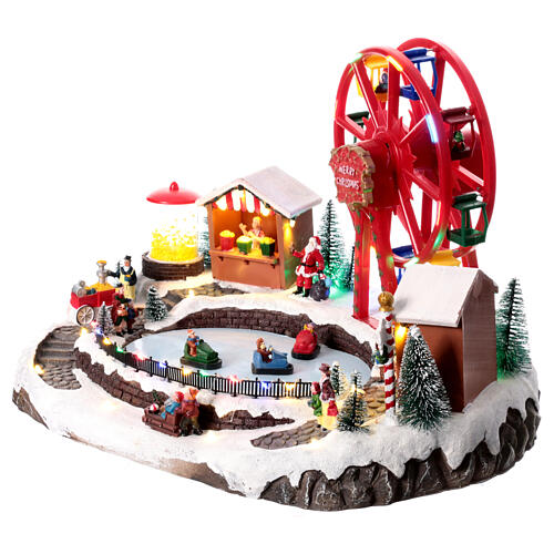 Pueblo navideño con tiovivos 30x30x45 cm 7
