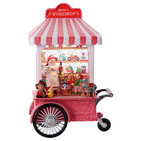Christmas snow globe with music box: Santa's workshop on a cart, 12x8x4 in