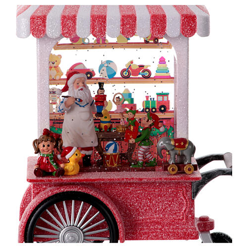 Christmas snow globe with music box: Santa's workshop on a cart, 12x8x4 in 2
