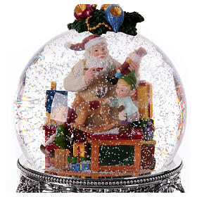 Boîte à musique boule à neige Père Noël avec elfes 25x20x20 cm