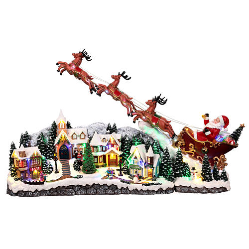 Weihnachtslandschaft mit fliegendem Weihnachtsmann, Schlitten, Rentieren, LED-Beleuchtung und Musik – 47×97,5×25,5 cm 1