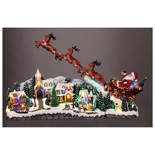 Weihnachtslandschaft mit fliegendem Weihnachtsmann, Schlitten, Rentieren, LED-Beleuchtung und Musik – 47×97,5×25,5 cm 2