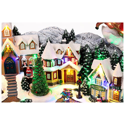 Weihnachtslandschaft mit fliegendem Weihnachtsmann, Schlitten, Rentieren, LED-Beleuchtung und Musik – 47×97,5×25,5 cm 4