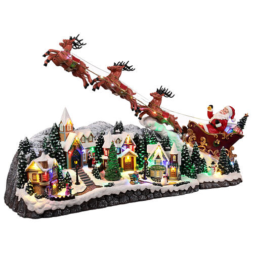 Weihnachtslandschaft mit fliegendem Weihnachtsmann, Schlitten, Rentieren, LED-Beleuchtung und Musik – 47×97,5×25,5 cm 5
