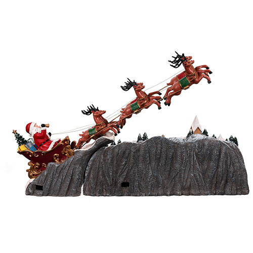 Weihnachtslandschaft mit fliegendem Weihnachtsmann, Schlitten, Rentieren, LED-Beleuchtung und Musik – 47×97,5×25,5 cm 10