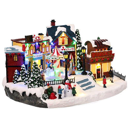 Christmas village with merry-go-round, motion lights and music, 8x16x12 in 5